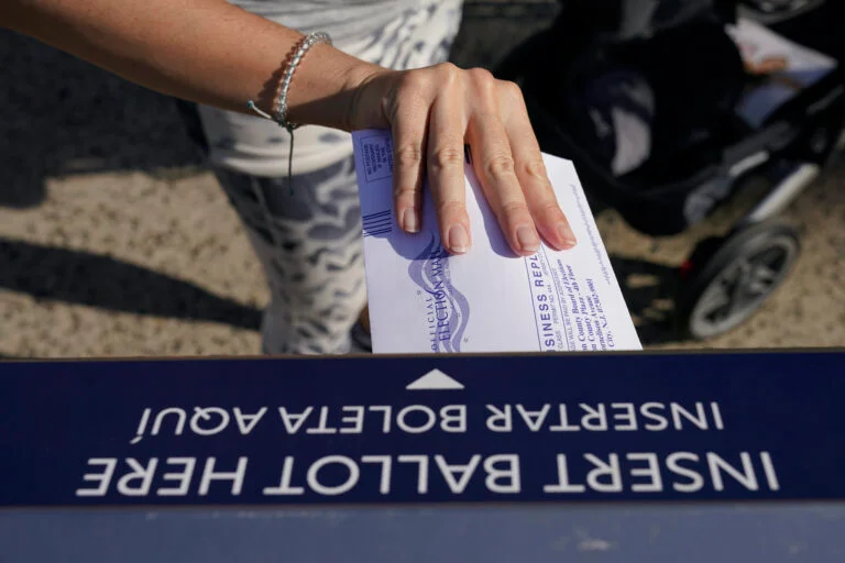 close up of a hand with a mail in ballot